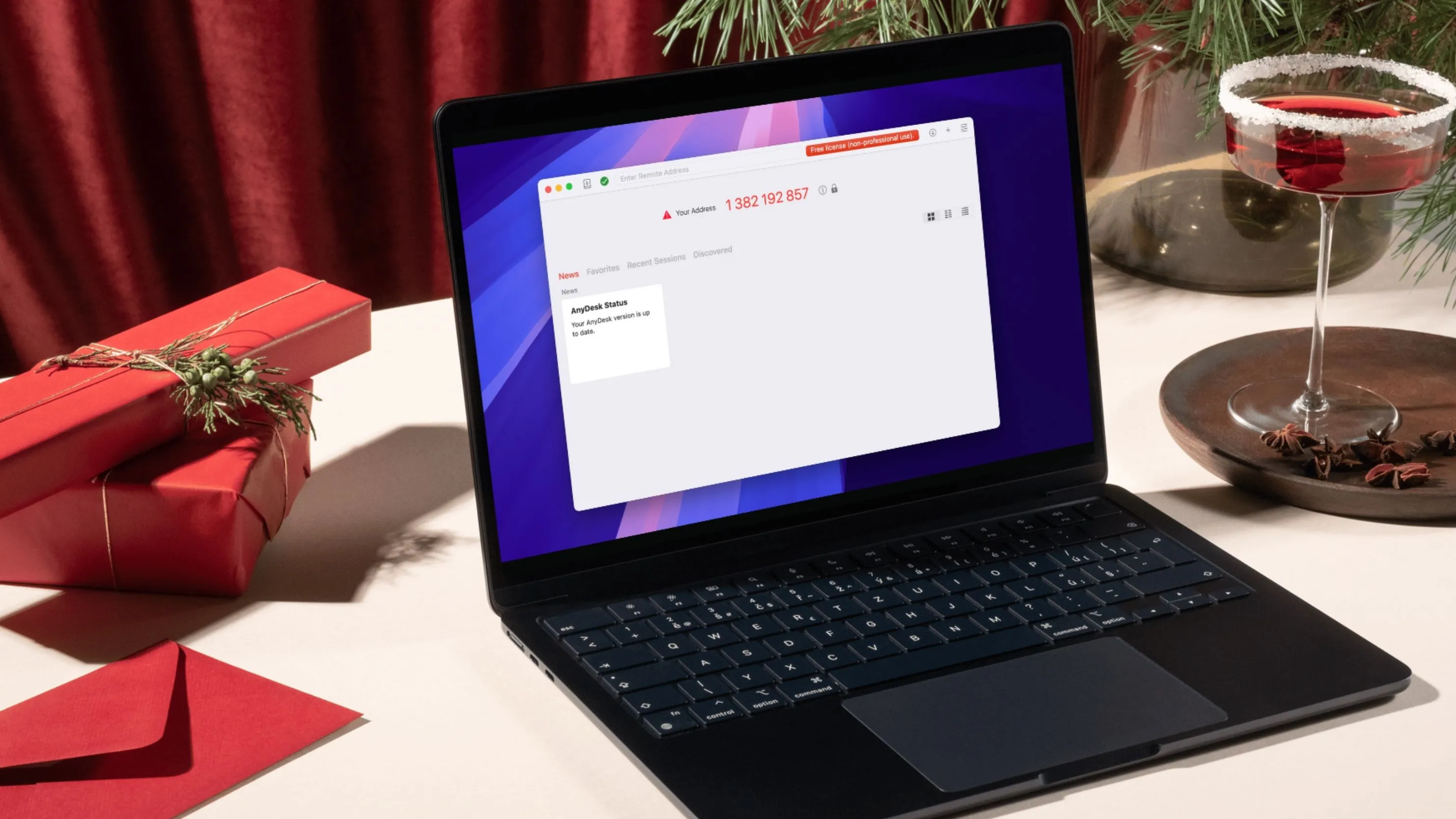 Laptop mở đặt cạnh ly rượu vang, gợi ý việc sử dụng AnyDesk như một lựa chọn thay thế an toàn và hiệu quả cho TeamViewer.