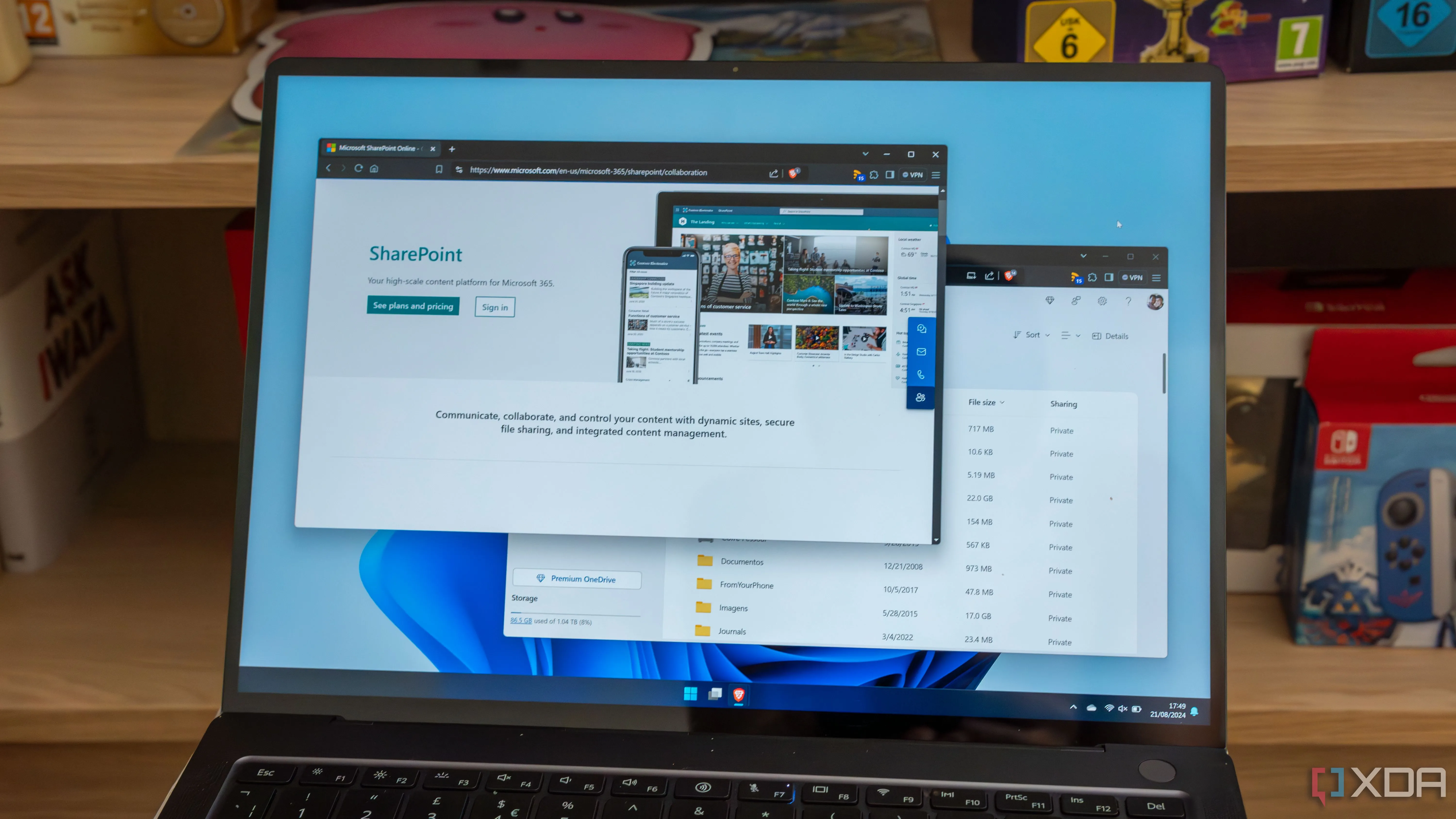 Màn hình laptop Windows 11 hiển thị tệp trên OneDrive và trang SharePoint của Microsoft.