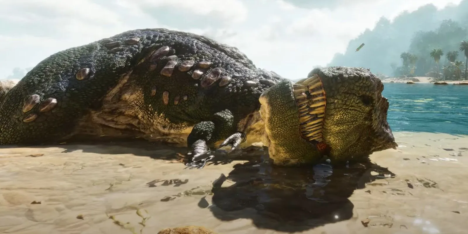 Một con khủng long bạo chúa T-Rex cấp thấp nằm trên bãi biển trong Ark: Survival Ascended
