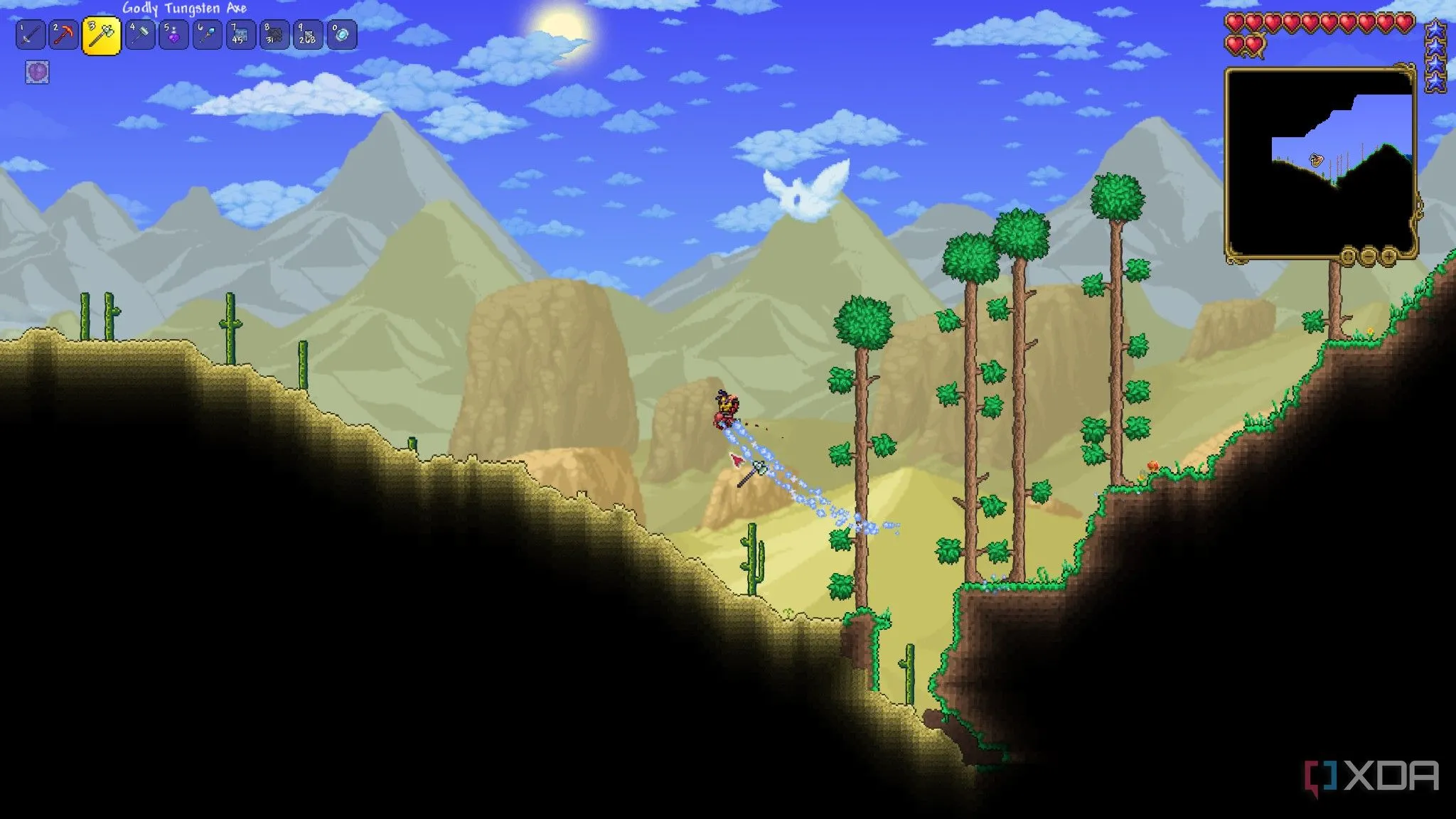 Một người chơi đứng giữa khung cảnh sa mạc trong Terraria, với các khối pixel đa dạng màu sắc và kẻ thù nhỏ.